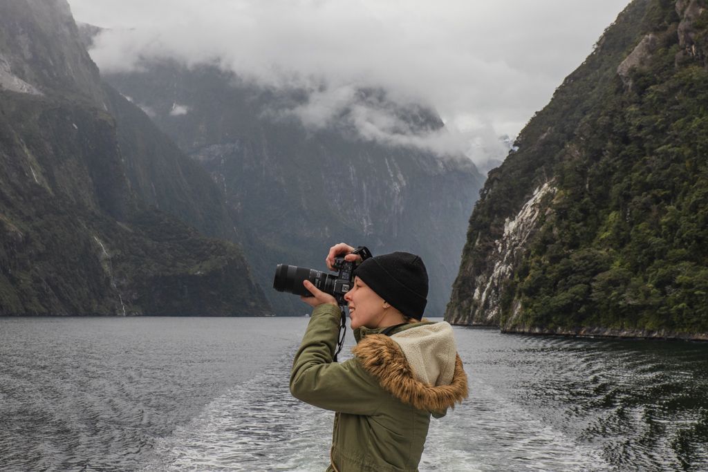 Abigail Hannah with her camera on the water in Milford Sound