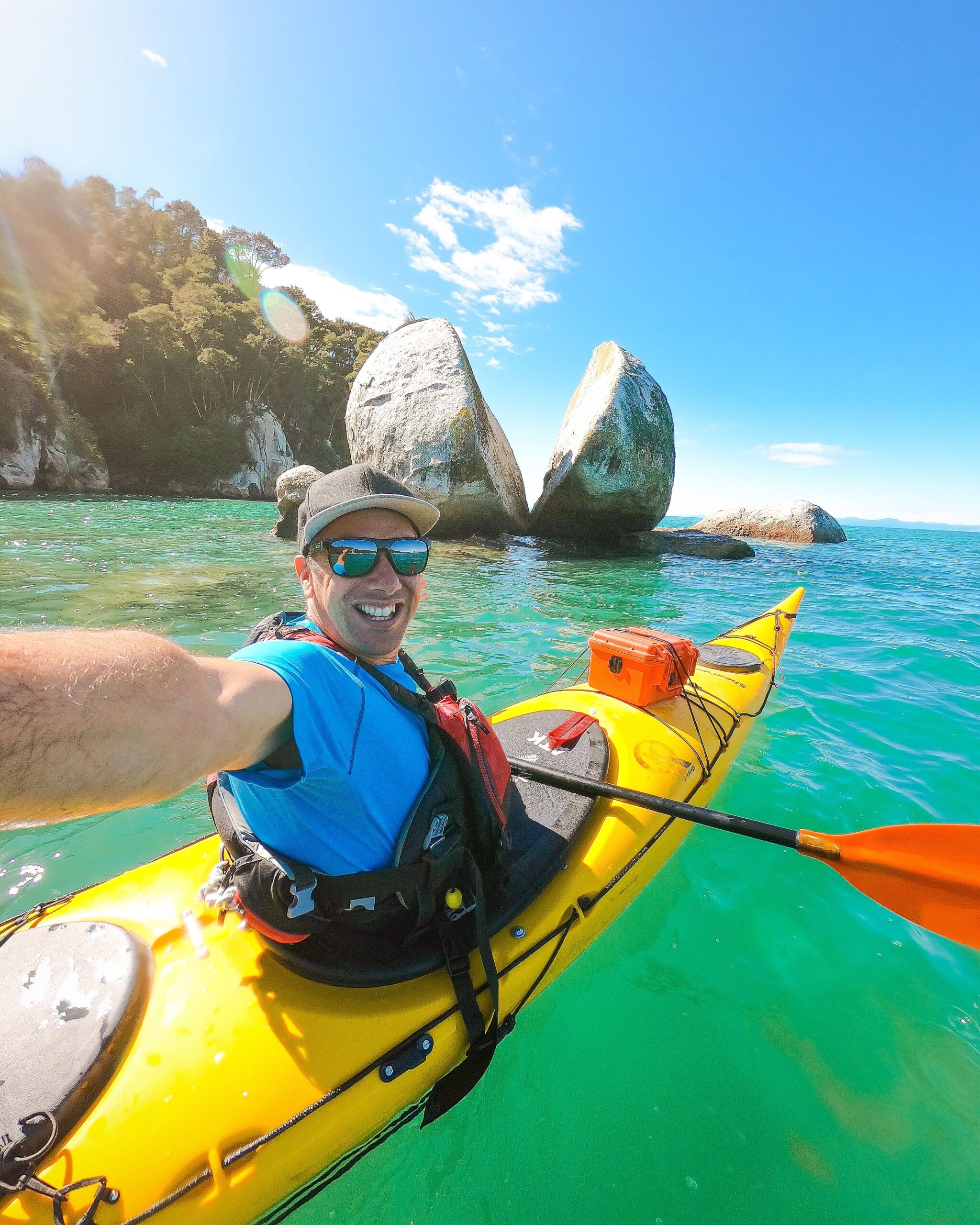 Man in kayak at Split Apple Rock, New Zealand